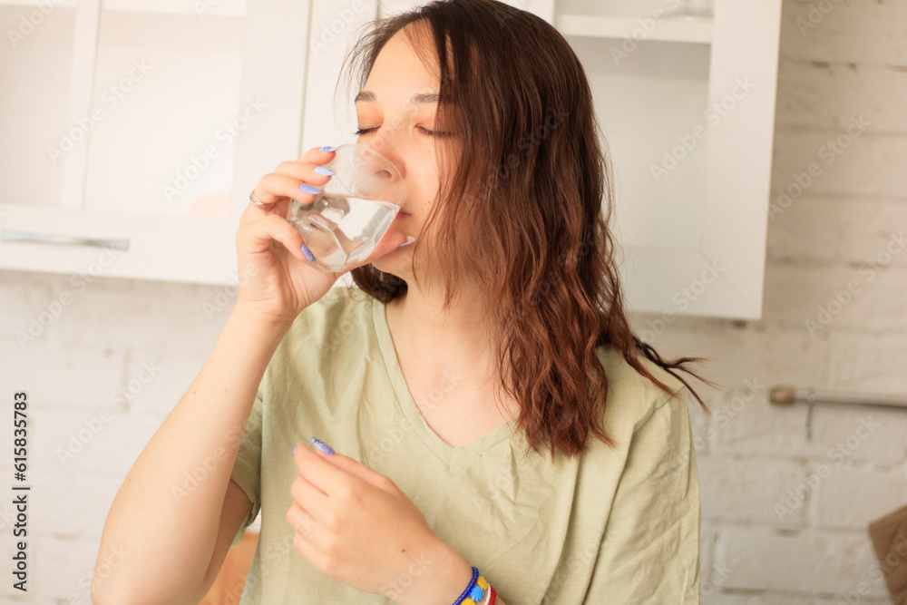 Close view of woman drinking glass of water with eyes closed sitting on couch. Close view of woman drinking glass of water with eyes closed sitting on couch.