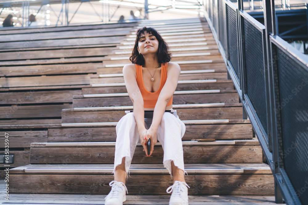 Stylish brunette resting on stairs Stylish brunette resting on stairs