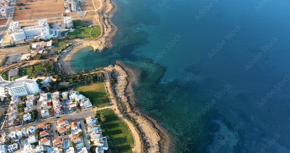 Drone shooting panorama of the coastline of the city with luxury hotels, villas, bays, ports with stylish yachts, sandy and rocky beaches and calm sea with clear blue water in Larnaca Cyprus.