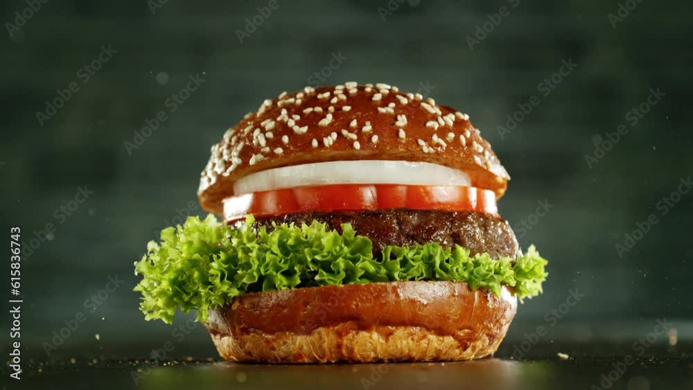 Super slow motion of stacking hamburger pieces. Camera in motion. Filmed on high speed cinema camera, 1000 fps. Placed on high speed cine bot. Speed ramp effect.