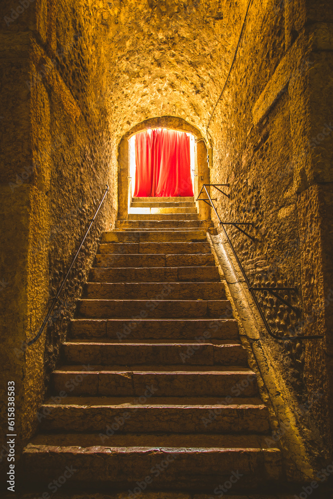 Old corridor with red curtain at the end. Concept for mystery, gothic, escape, hope.