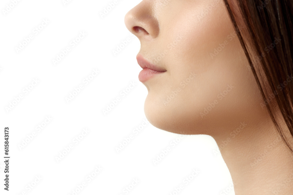 Close-up cropped profile image of female face part, chin, lips and nose over white studio background. Double chin surgery. Concept of natural female beauty, body and skincare, cosmetology, health, ad Close-up cropped profile image of female face part, chin, lips and nose over white studio background. Double chin surgery. Concept of natural female beauty, body and skincare, cosmetology, health, ad