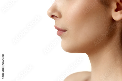Close-up cropped profile image of female face part, chin, lips and nose over white studio background. Double chin surgery. Concept of natural female beauty, body and skincare, cosmetology, health, ad