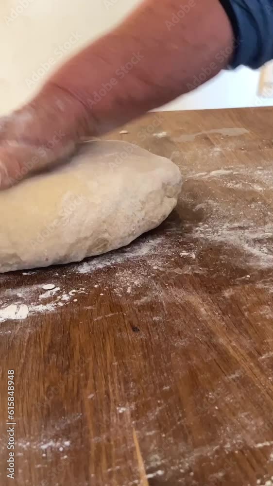 kind old hands of an elderly woman grandmother roll out the dough she will cook pies and bake something or boil dumplings or dumplings on a wooden surface soft fresh dough. High quality 4k footage kind old hands of an elderly woman grandmother roll out the dough she will cook pies and bake something or boil dumplings or dumplings on a wooden surface soft fresh dough. High quality 4k footage