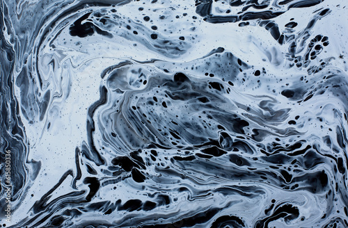 Hand painted background with mixed liquid blue and white paints. Abstract fluid acrylic painting.