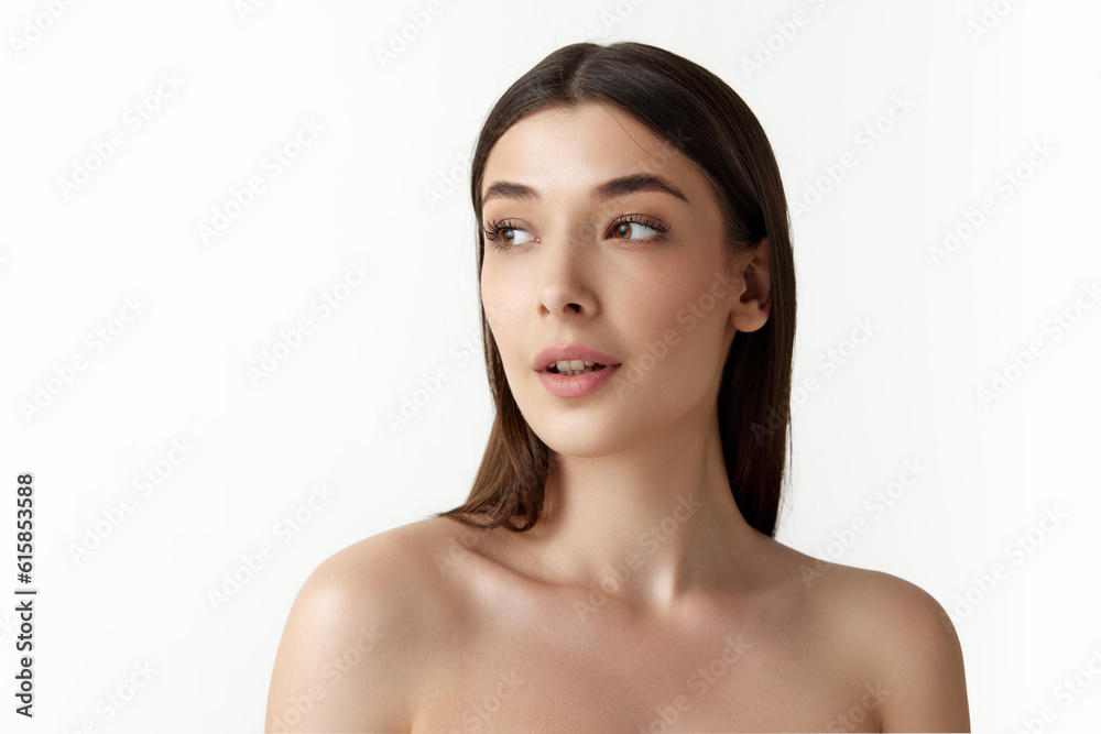 Tender young brunette woman with straight hair and well-kept smooth skin posing against white studio background. Concept of natural female beauty, body and skincare, cosmetology, health, ad Tender young brunette woman with straight hair and well-kept smooth skin posing against white studio background. Concept of natural female beauty, body and skincare, cosmetology, health, ad