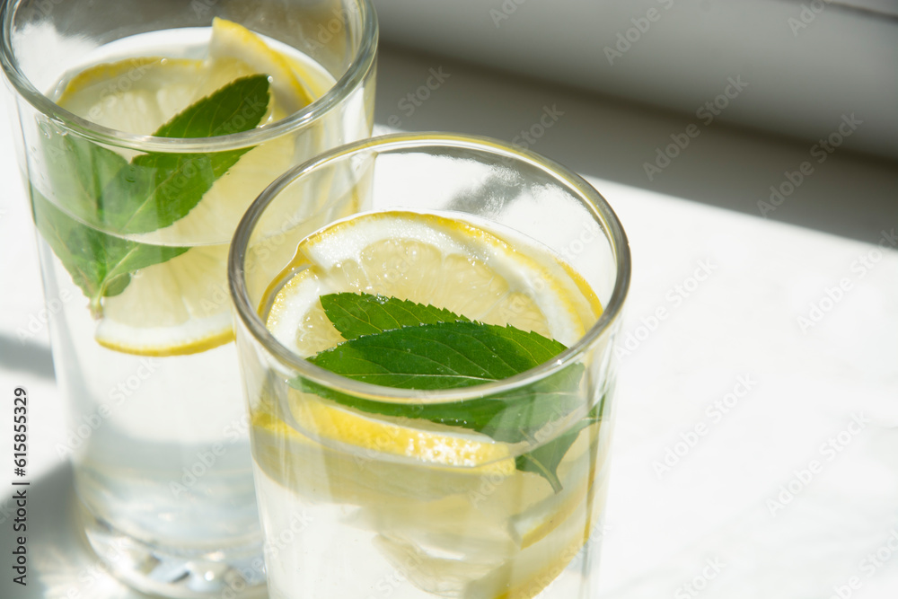 Lemon water with ice and mint in glass