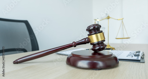 Judge gavel, scales of justice on the office desk, the white background office of a lawyer or judge.