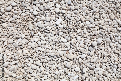 Fototapeta Naklejka Na Ścianę i Meble -  White stone beach background in Sardinia island, Italy. White zen stone texture.