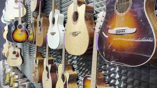 Shop for acoustic guitars of various sizes and colors. Concept of musical instruments