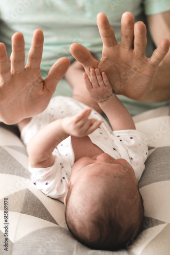 Obraz na plátně A baby playing with his father's hands