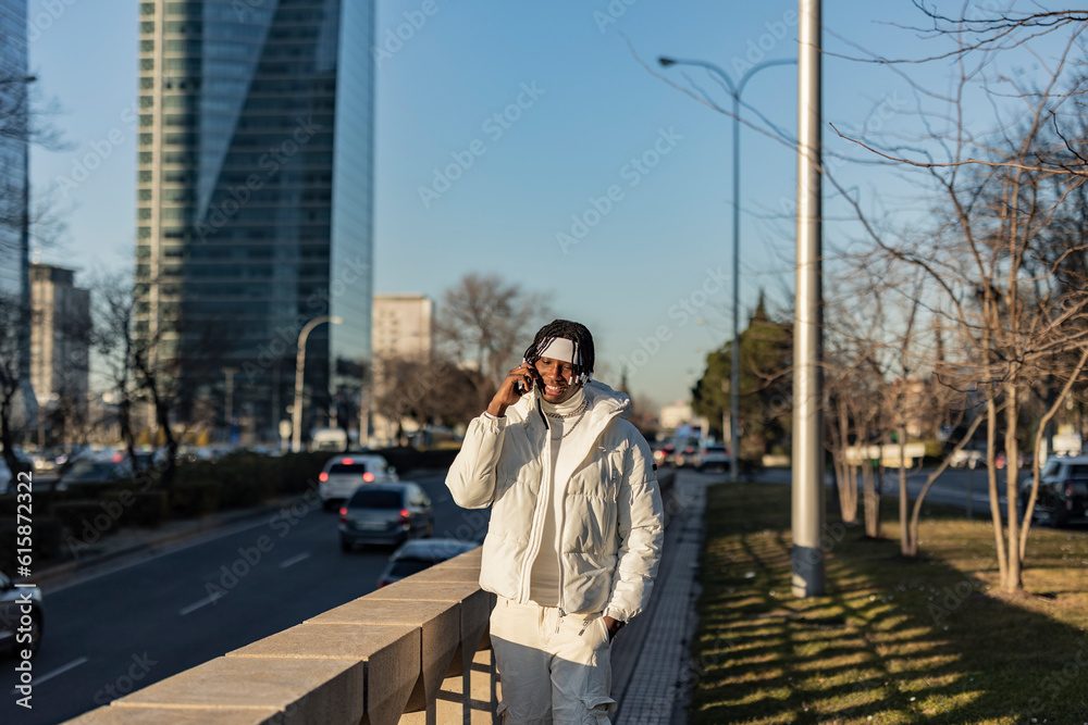 young african guy in the city with smart phone