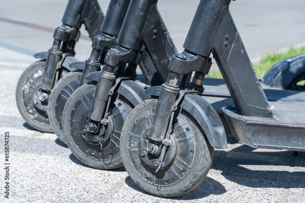 Obraz premium Details mechanism of used electric scooter close up. Wheel, shock absorber public mobile transport. Equipment technology economical vehicle in contemporary urban. Device ecological dockless transport.