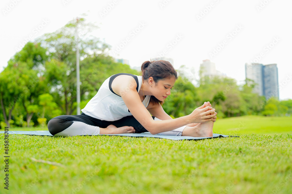 Pleasant millennial woman practice yoga outdoor in the morning during wellness retreat. Pleasant millennial woman practice yoga outdoor in the morning during wellness retreat.