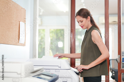 Foto Young Woman Copying Document With Photocopy In Office