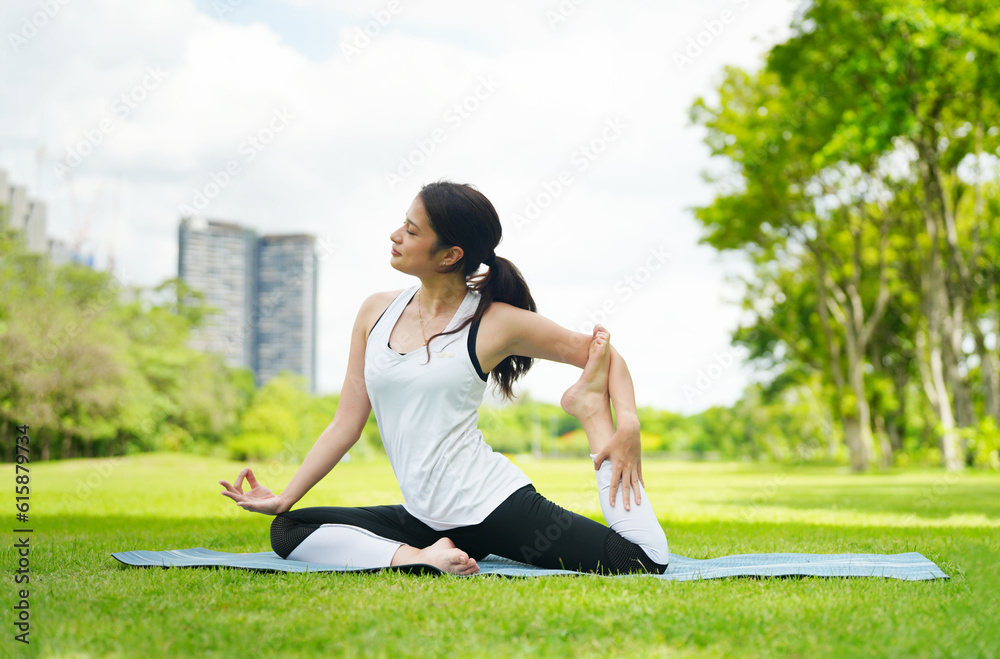Pleasant millennial woman practice yoga outdoor in the morning during wellness retreat.