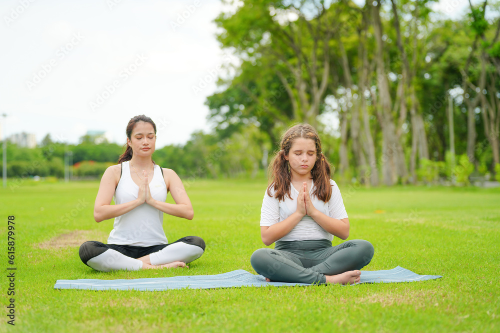 Pleasant millennial woman practice yoga outdoor in the morning during wellness retreat. Pleasant millennial woman practice yoga outdoor in the morning during wellness retreat.
