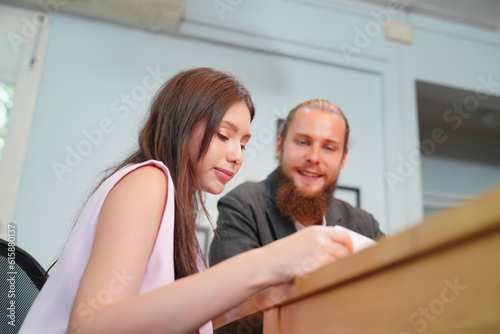 Young office worker presenting new financial plan to his partners during a meeting © FotoArtist