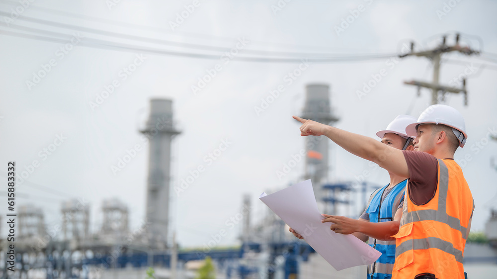 Two engineer working at power plant,Work together happily,Help each other analyze the problem,Consult about development guidelines Two engineer working at power plant,Work together happily,Help each other analyze the problem,Consult about development guidelines