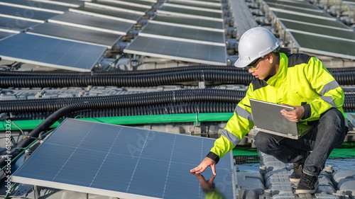 Asian engineer working at Floating solar power plant,Renewable energy,Technician and investor solar panels checking the panels at solar energy installation