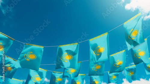 Flag of Kazakhstan against the sky, flags hanging vertically