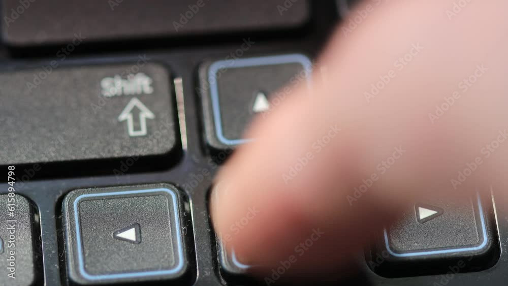 finger presses on the arrow button on the laptop keyboard finger presses on the arrow button on the laptop keyboard