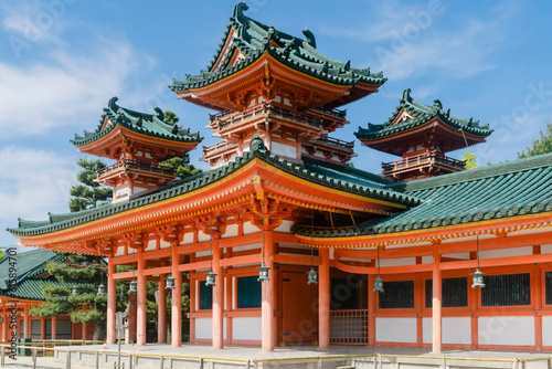 Detail of abstract Shinto temple roof featuring traditional green and orange ornament in park in Kyoto  Japan