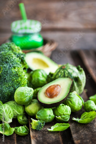Assortment of fresh green vegetables on wooden table
