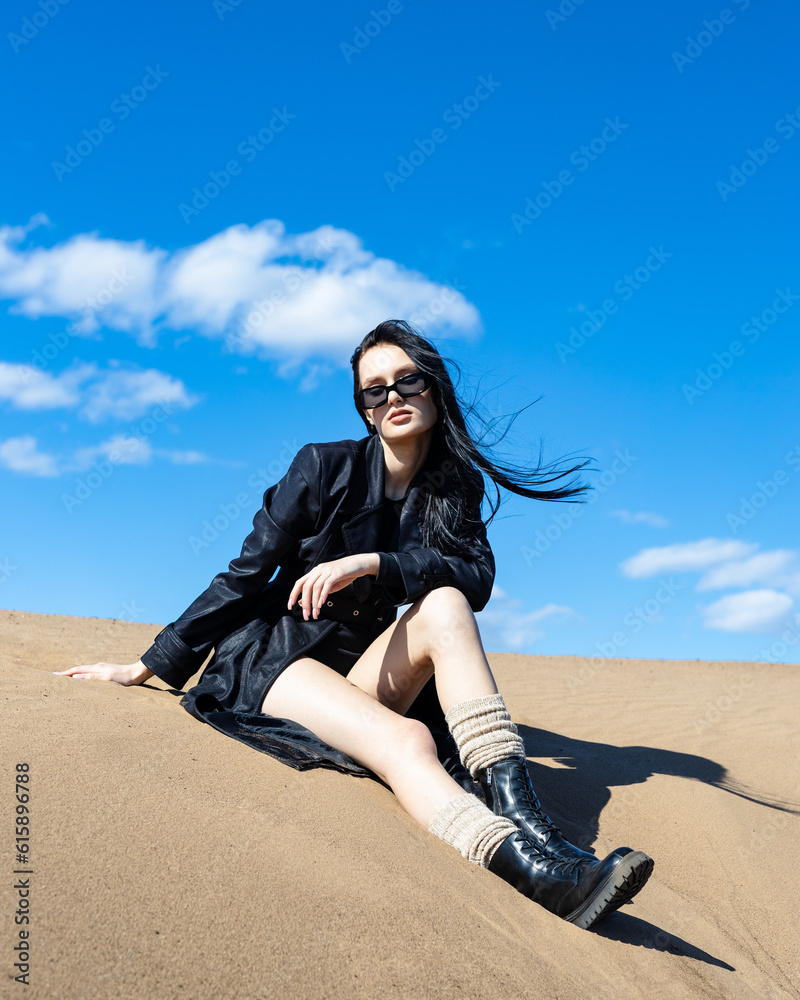 Happy young woman in warm clothes standing fashion posing near river bank alone on cool sunny day, relaxing and enjoying freedom. Outdoors weekend activity, water scenery Happy young woman in warm clothes standing fashion posing near river bank alone on cool sunny day, relaxing and enjoying freedom. Outdoors weekend activity, water scenery