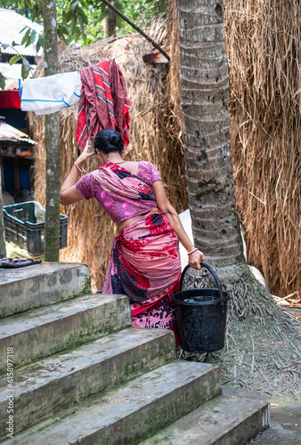 Rural woman carrying safe drinking water for family uses