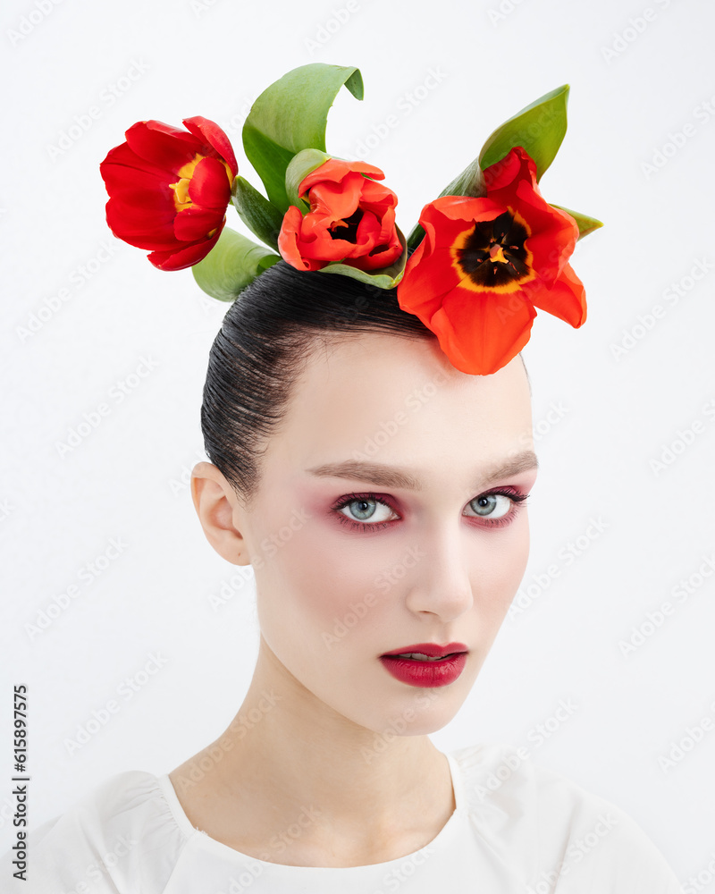 Beauty Summer model girl with tulip flowers Flowers. Beautiful lady with blooming flowers on her head. Nature hairstyle. Festive Fashion Makeup