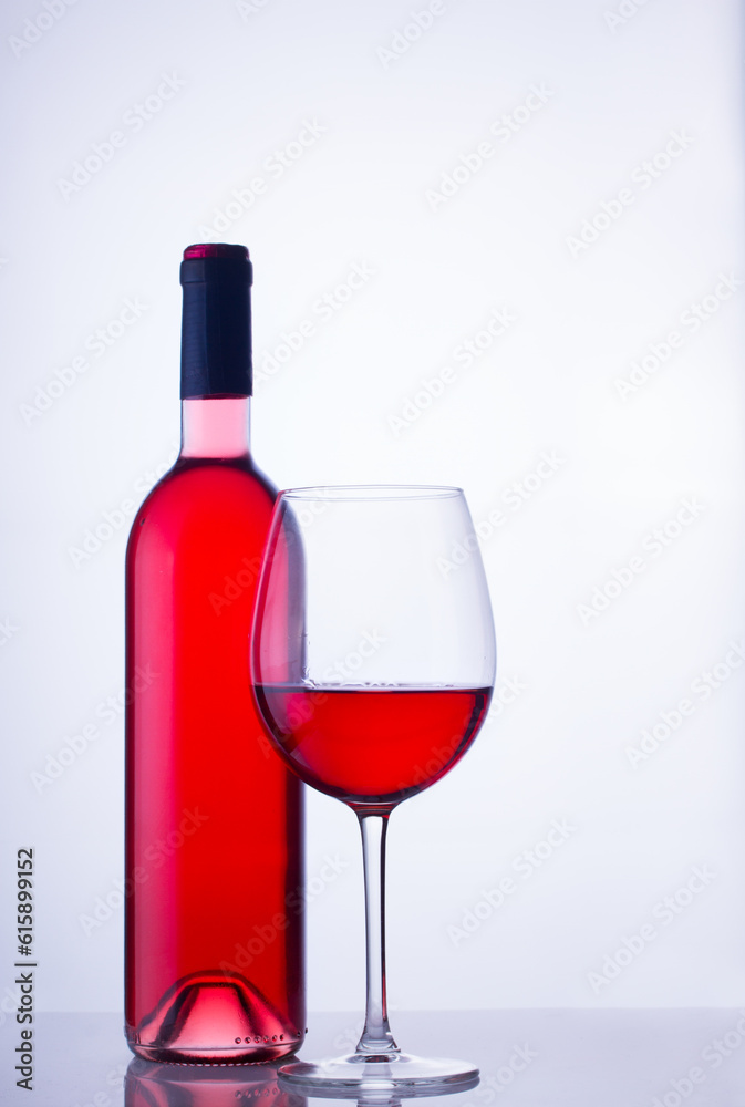 High glass with still rose wine and wine bottle High glass with still rose wine and wine bottle