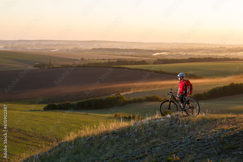 Traveler in red jersey and white helmet ride a bike on autumn background
