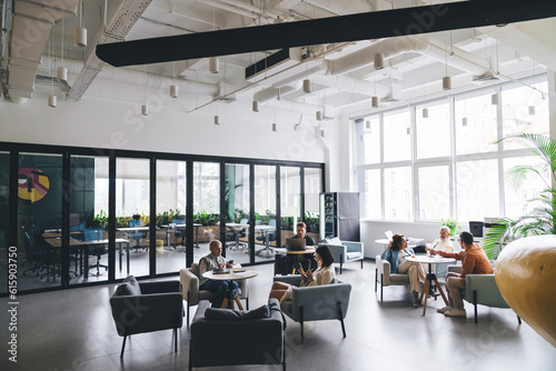 Group of coworkers in spacious workplace