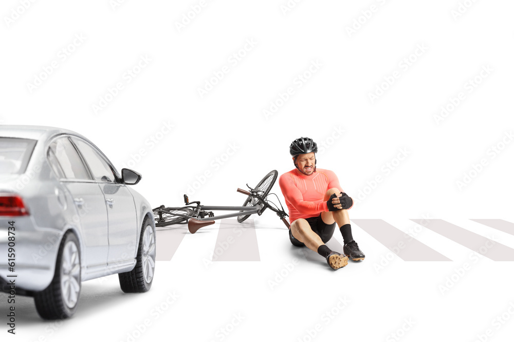 Mature male bicycle rider sitting on a street and holding his painful knee Mature male bicycle rider sitting on a street and holding his painful knee