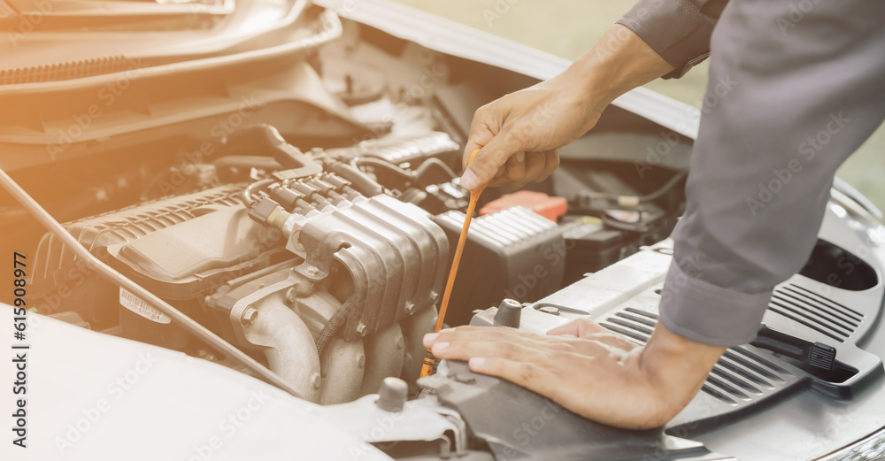 Obraz premium Automobile mechanic repairman hands repairing a car engine automotive workshop with a wrench, car service and maintenance,Repair service.