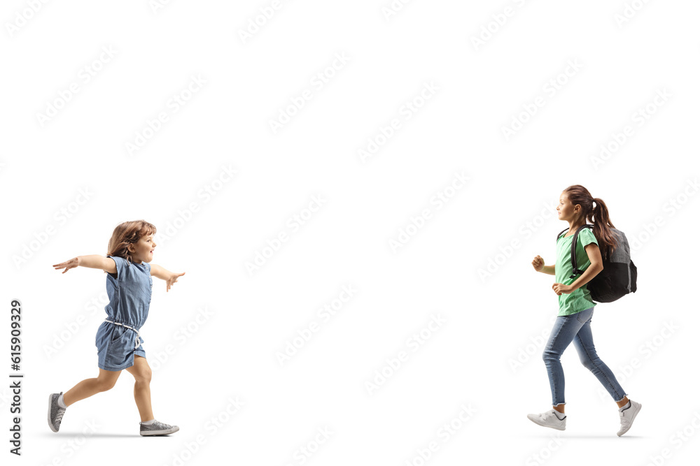 Little girl running to hug a her older sister Little girl running to hug a her older sister
