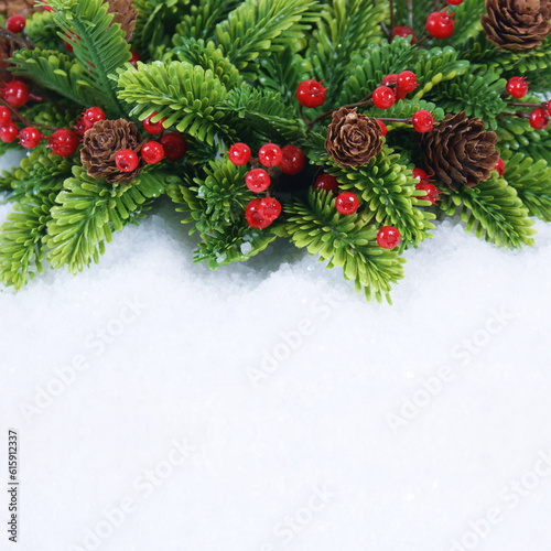 Christmas wreath with pine cones and berries nestled in snow