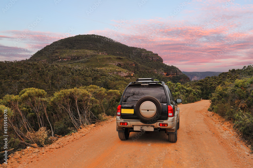 Exploring the magnificent Blue Mountains Australia.  A four wheel drive 4WD traveling along a dirt track in the Blue Mountains