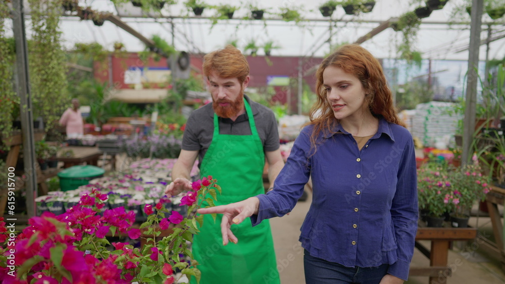 Male Flower Shop Employee Assisting Female Client_ Store Visit and Purchase with Apron Male Flower Shop Employee Assisting Female Client_ Store Visit and Purchase with Apron