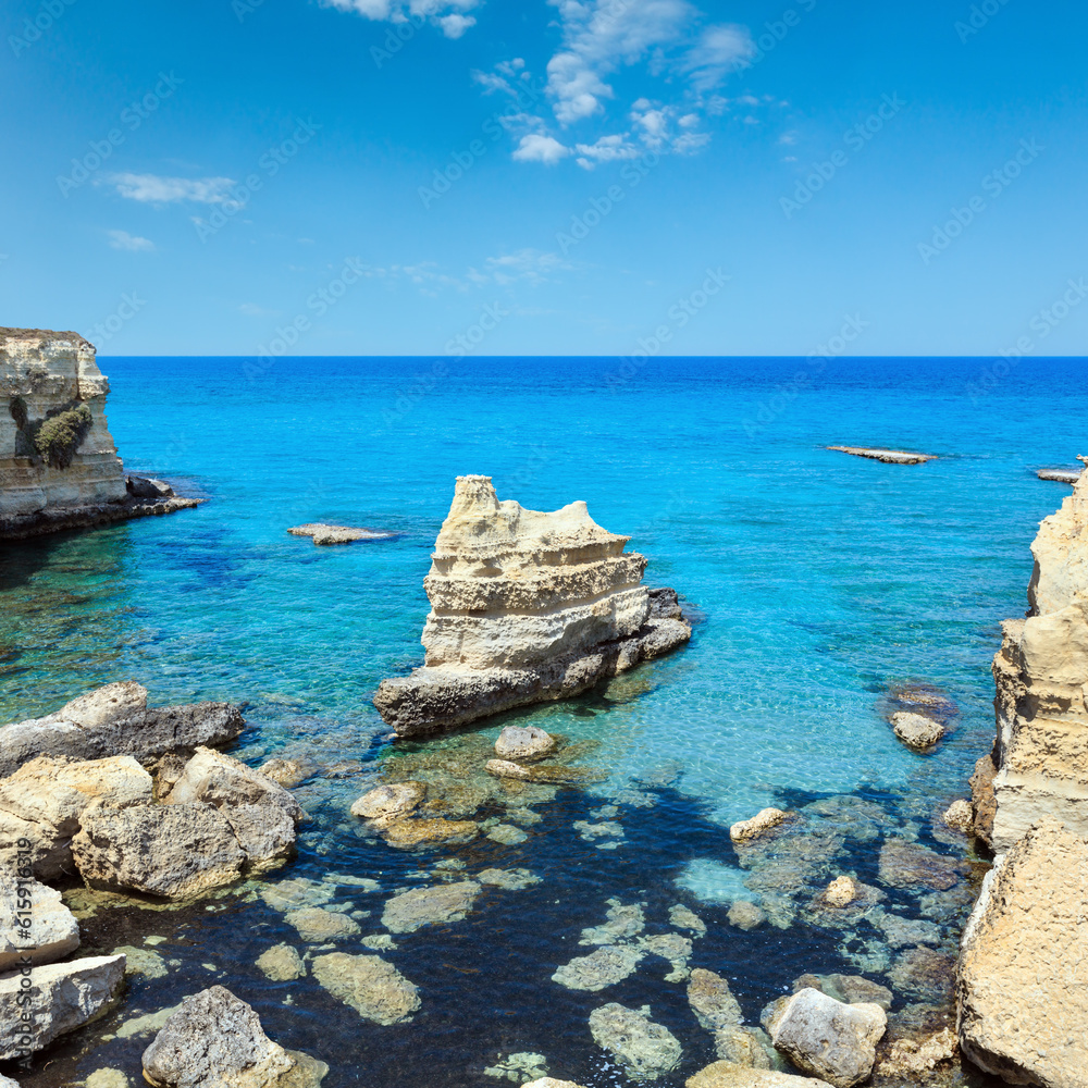 Picturesque seascape with white rocky cliffs, sea bay, islets and faraglioni at beach Spiaggia della Punticeddha, Salento Adriatic sea coast, Puglia, Italy