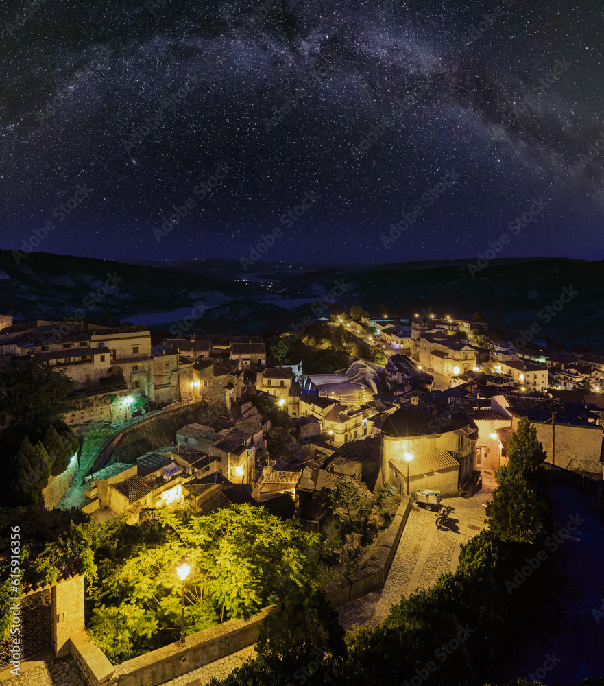 Night old medieval Stilo famos Calabria village view with Milky Way galaxy stars above , southern Italy.