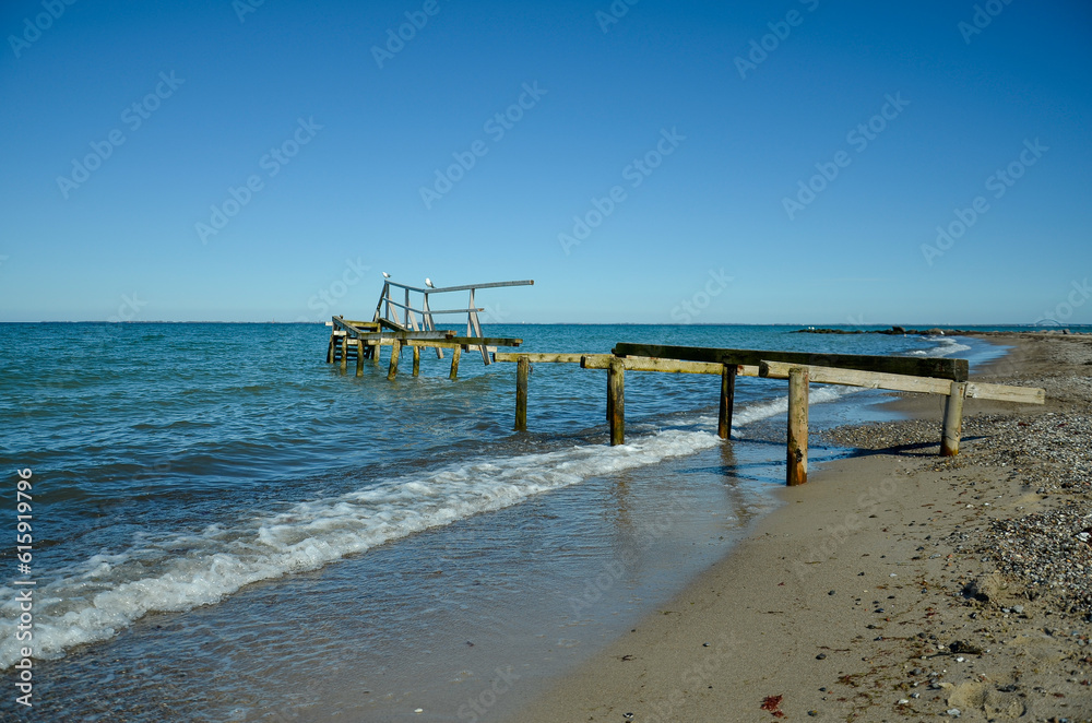 Beach in Heiligenhafen with sea view and old rotten wooden jetty