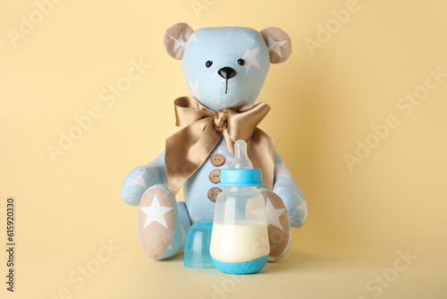 Teddy bear with bottle of m...