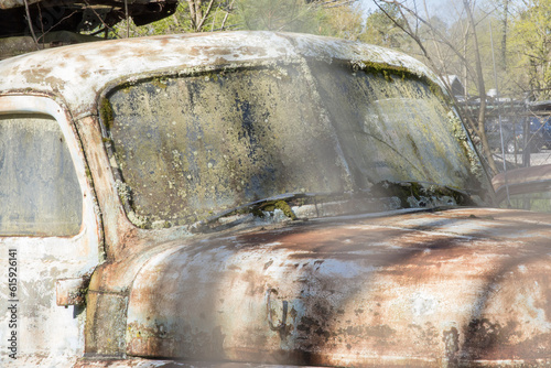 Old rusty cars in a junk yard