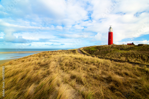 Lighthouse Texel on Blue Cloudy Sky background Outdoors. Nationalpark Duinen van Texel, Texel Island, Netherlands photo
