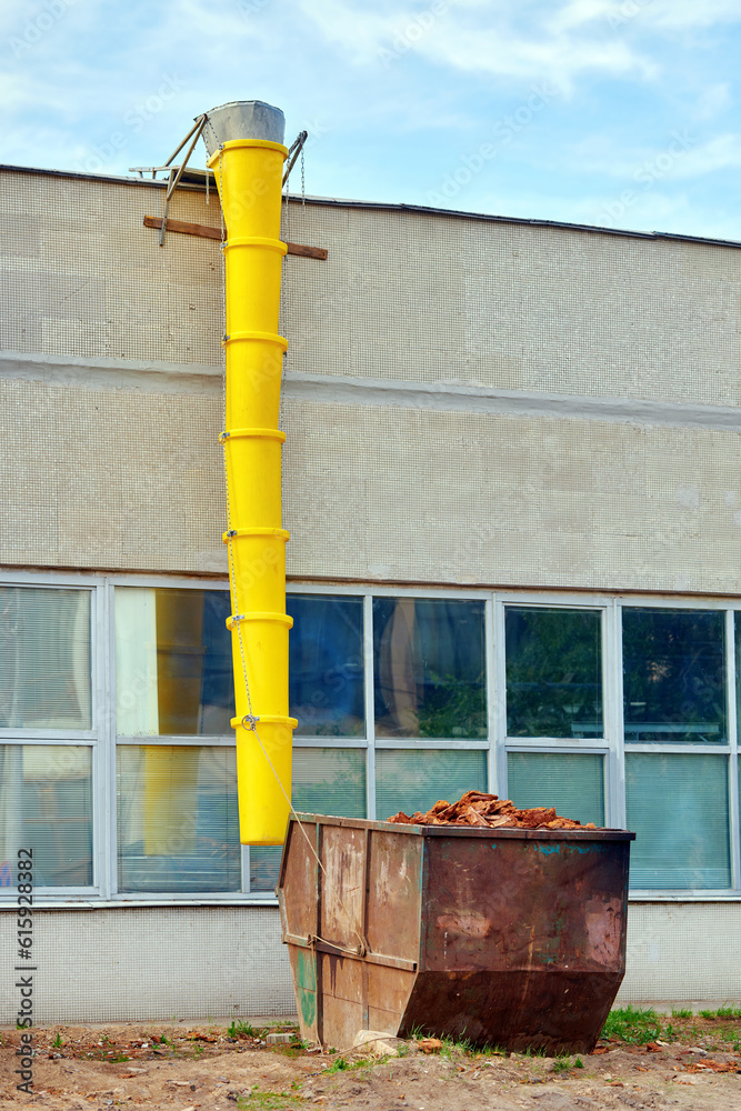 Debris chute and waste container, disposal of construction waste during