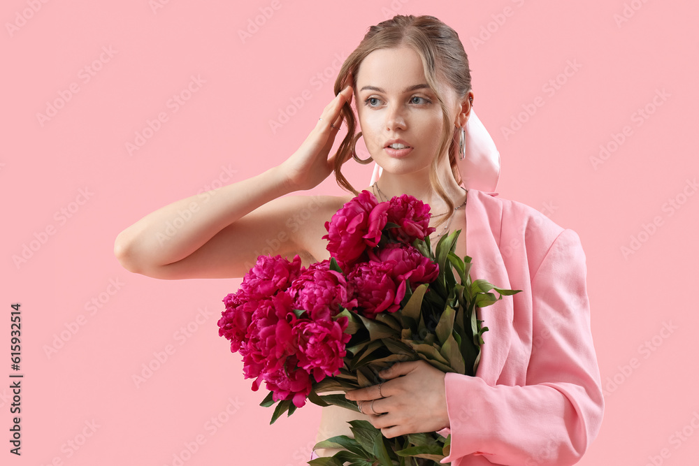 Beautiful young woman with bouquet of peony flowers on pink background
