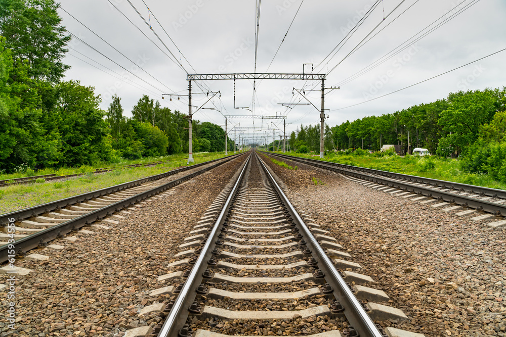 Train tracks go over the horizon line. Cloudy weather Train tracks go over the horizon line. Cloudy weather