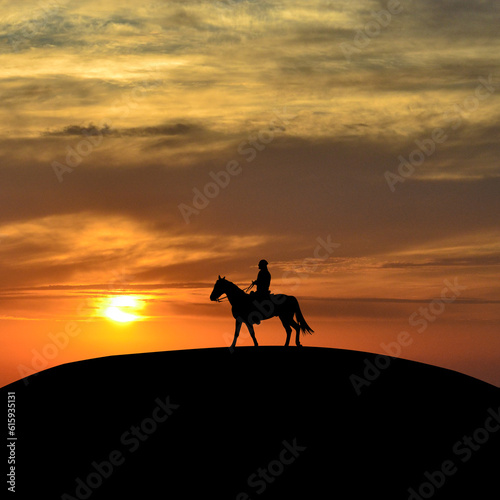Horseback rider at sunset